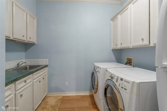 a utility room with sink dryer and washer