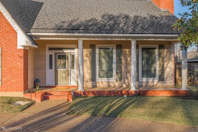 a view of a brick house with large windows