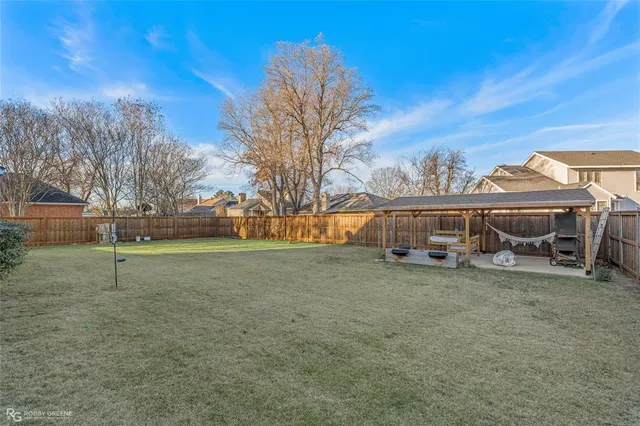 a view of a house with backyard porch and sitting area