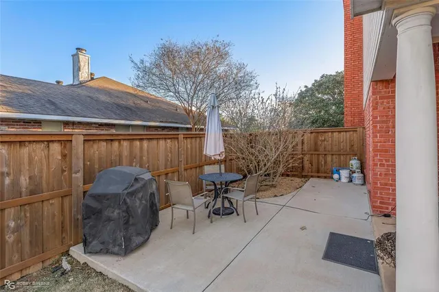 a view of a patio with table and chairs a barbeque