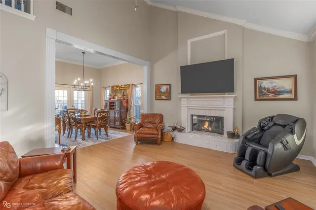 a living room with furniture a fireplace and a flat screen tv