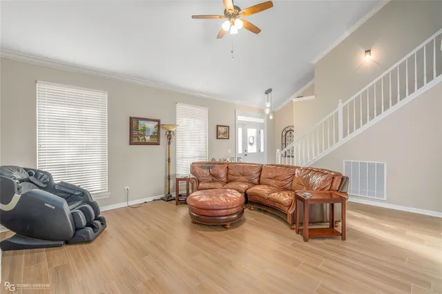 a living room with furniture and a wooden floor