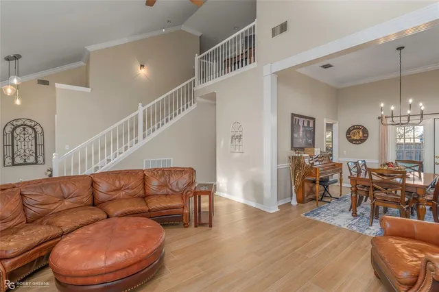 a living room with furniture a dining table and wooden floor