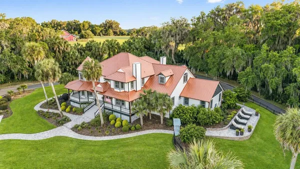 an aerial view of a house with swimming pool and garden