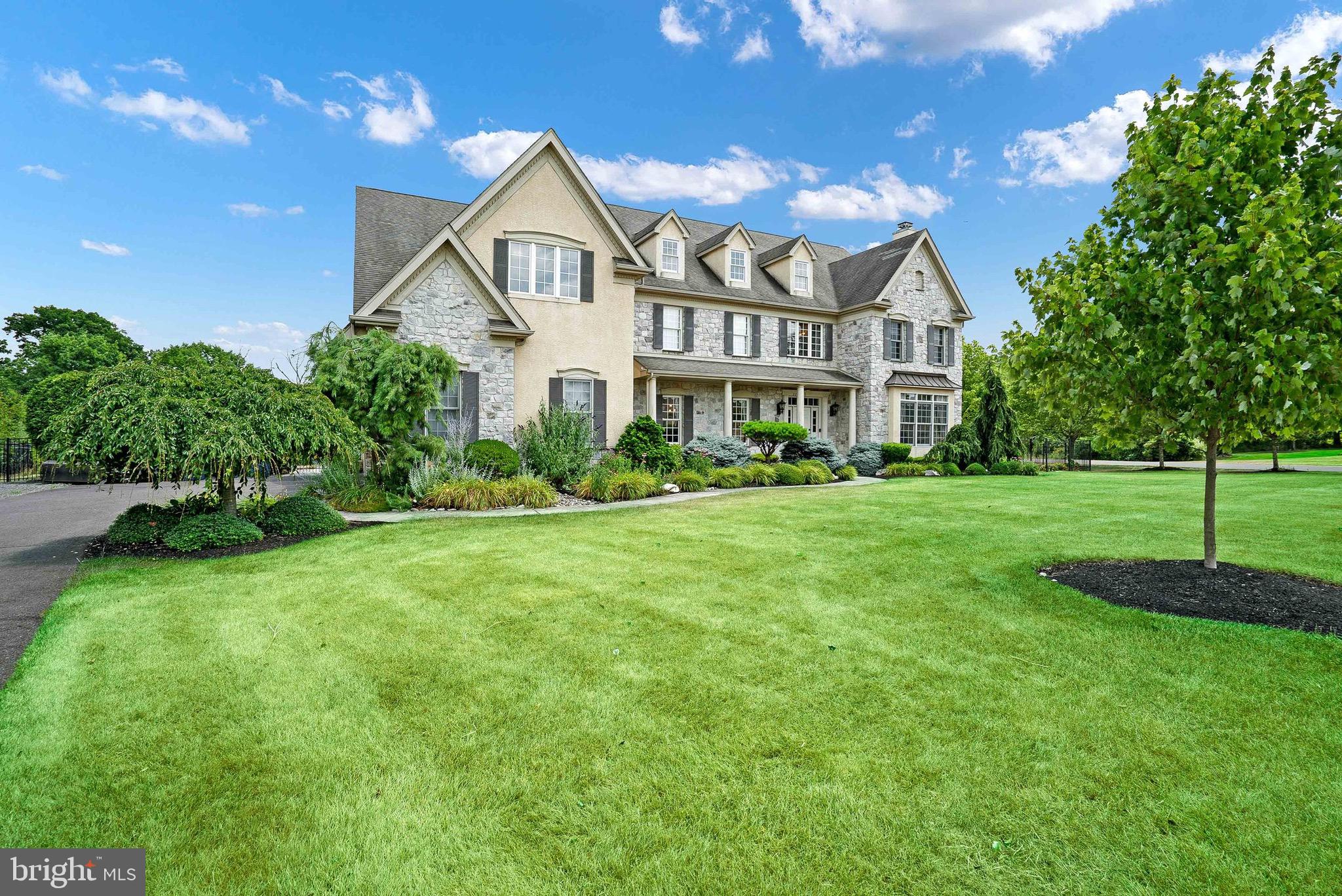2221 Devin Lane Jamison, PA 18929 - Photo 2 of 12 a view of a white house next to a yard with big trees