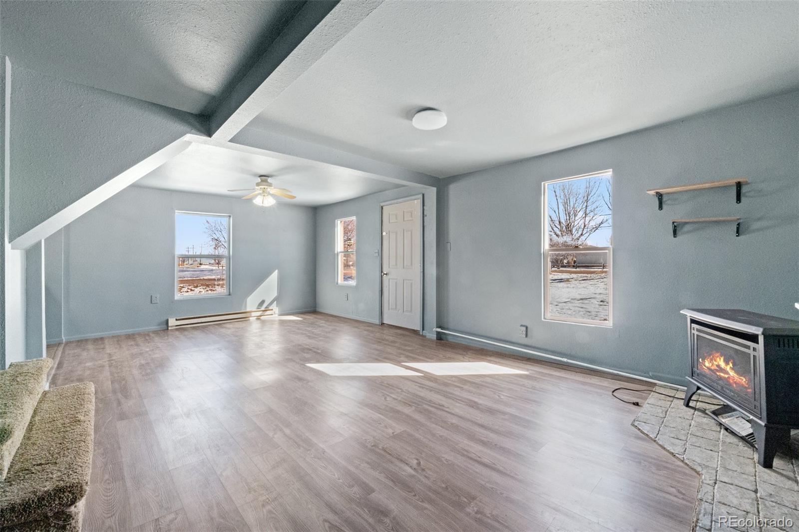 620 Hospital Road Brush, CO 80723 - Photo 13 of 24 a view of a livingroom with wooden floor and a fireplace