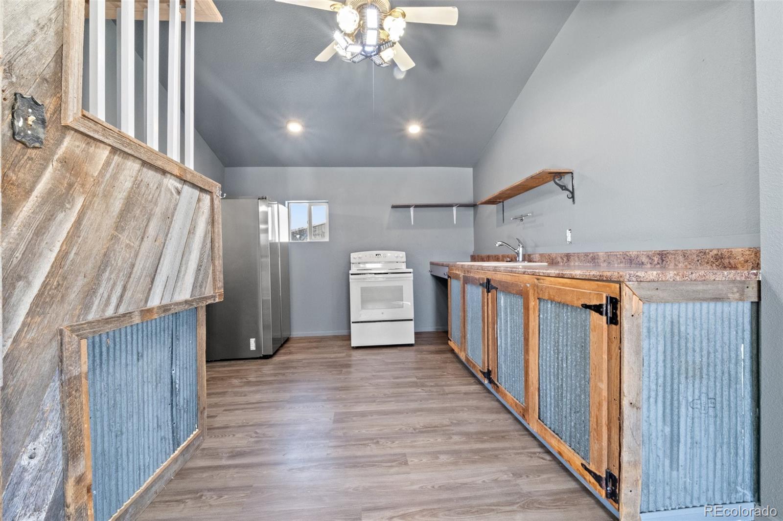 620 Hospital Road Brush, CO 80723 - Photo 9 of 24 a storage room with wooden floor and staircase