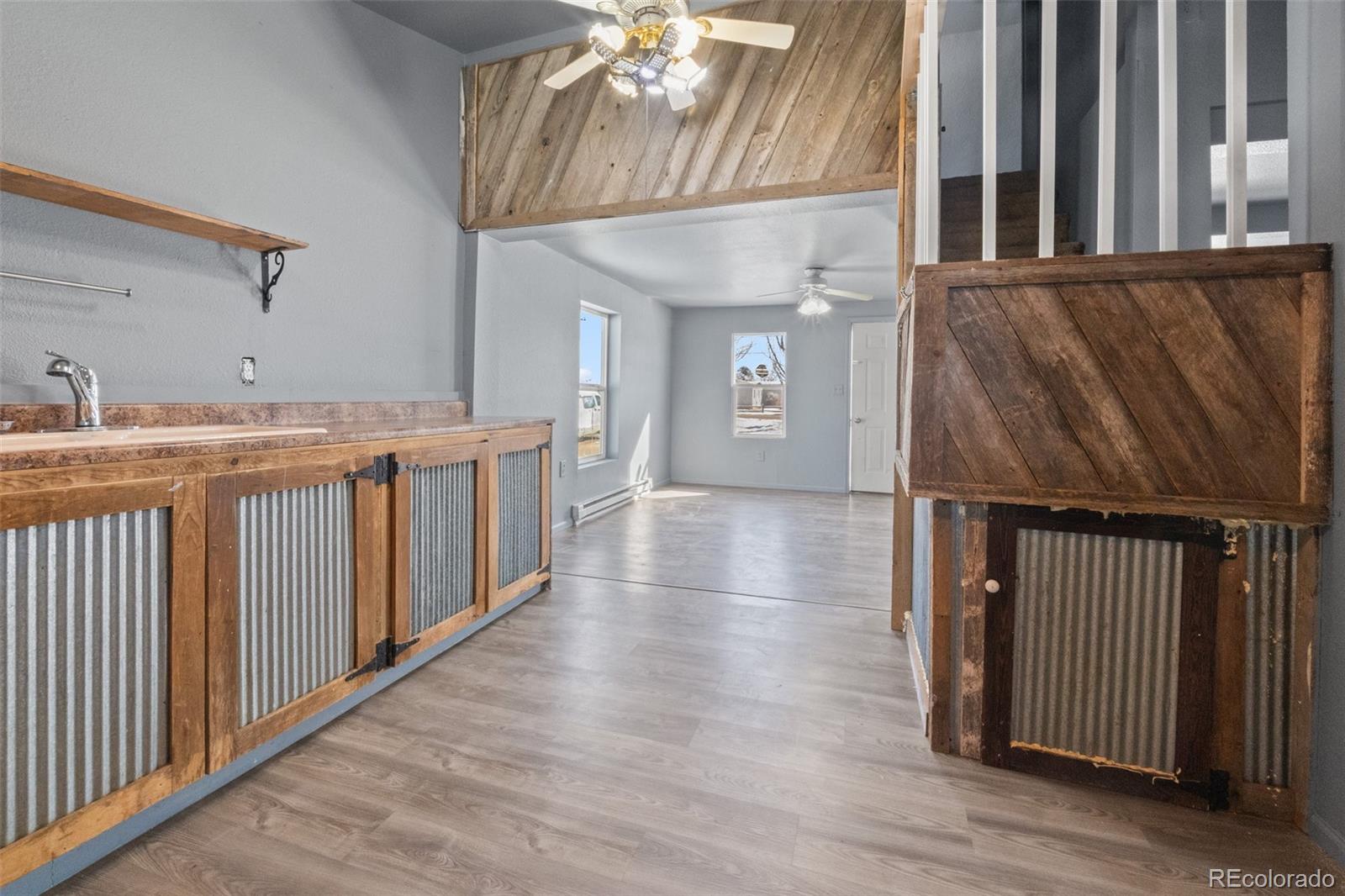 620 Hospital Road Brush, CO 80723 - Photo 10 of 24 a view of a hallway with wooden floor and staircase