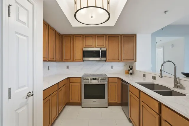 a kitchen with a sink a stove and cabinets