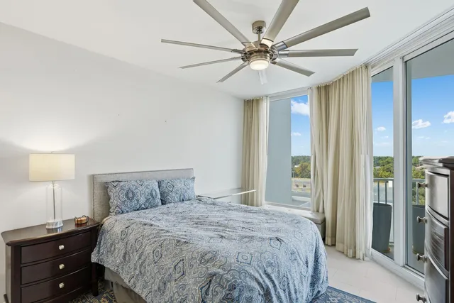 a bedroom with a large bed and a chandelier