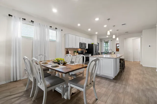 a view of a dining room with furniture and wooden floor