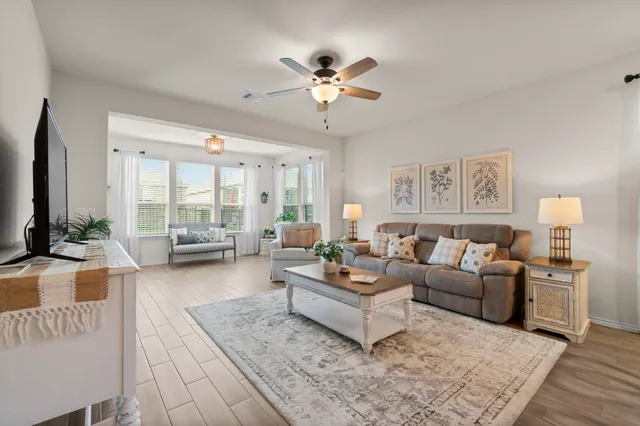 a living room with furniture and a large window
