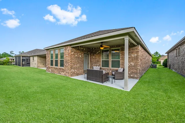 a view of a house with a backyard