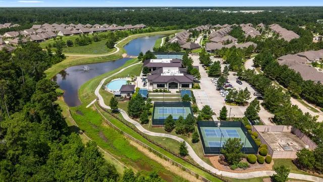 an aerial view of a house with outdoor space and lake view