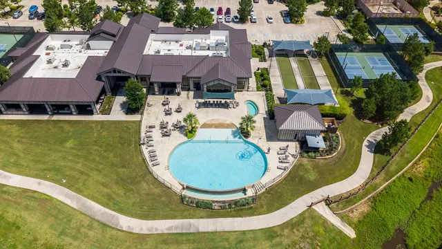 an aerial view of a house with swimming pool and outdoor seating