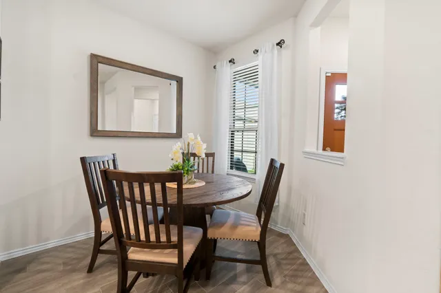 a view of a dining room with furniture and window