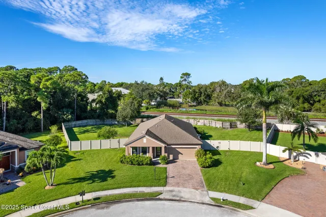 an aerial view of a house with a yard