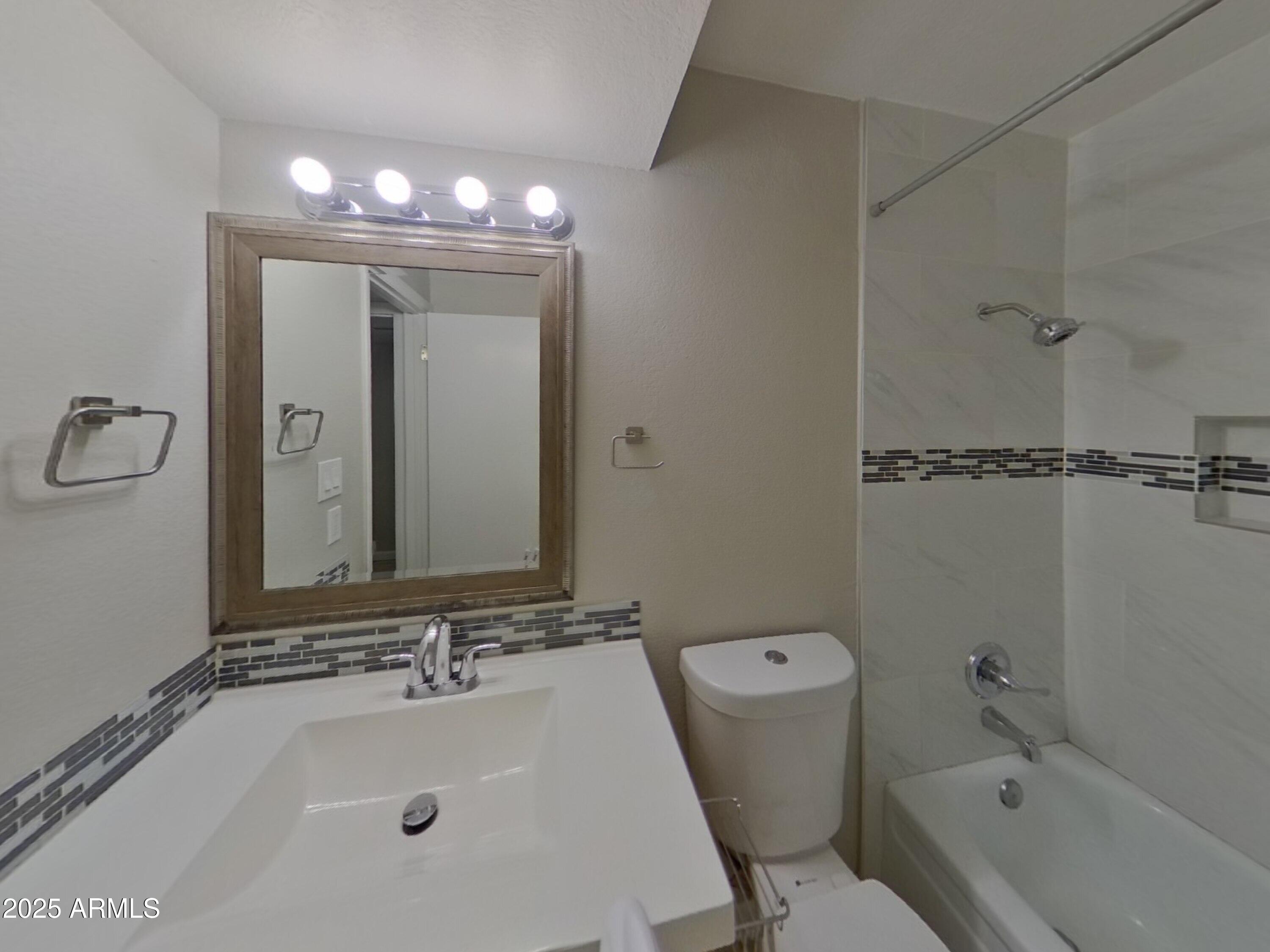 845 South Vineyard Mesa, AZ 85210 - Photo 20 of 26 a bathroom with a sink a toilet and shower