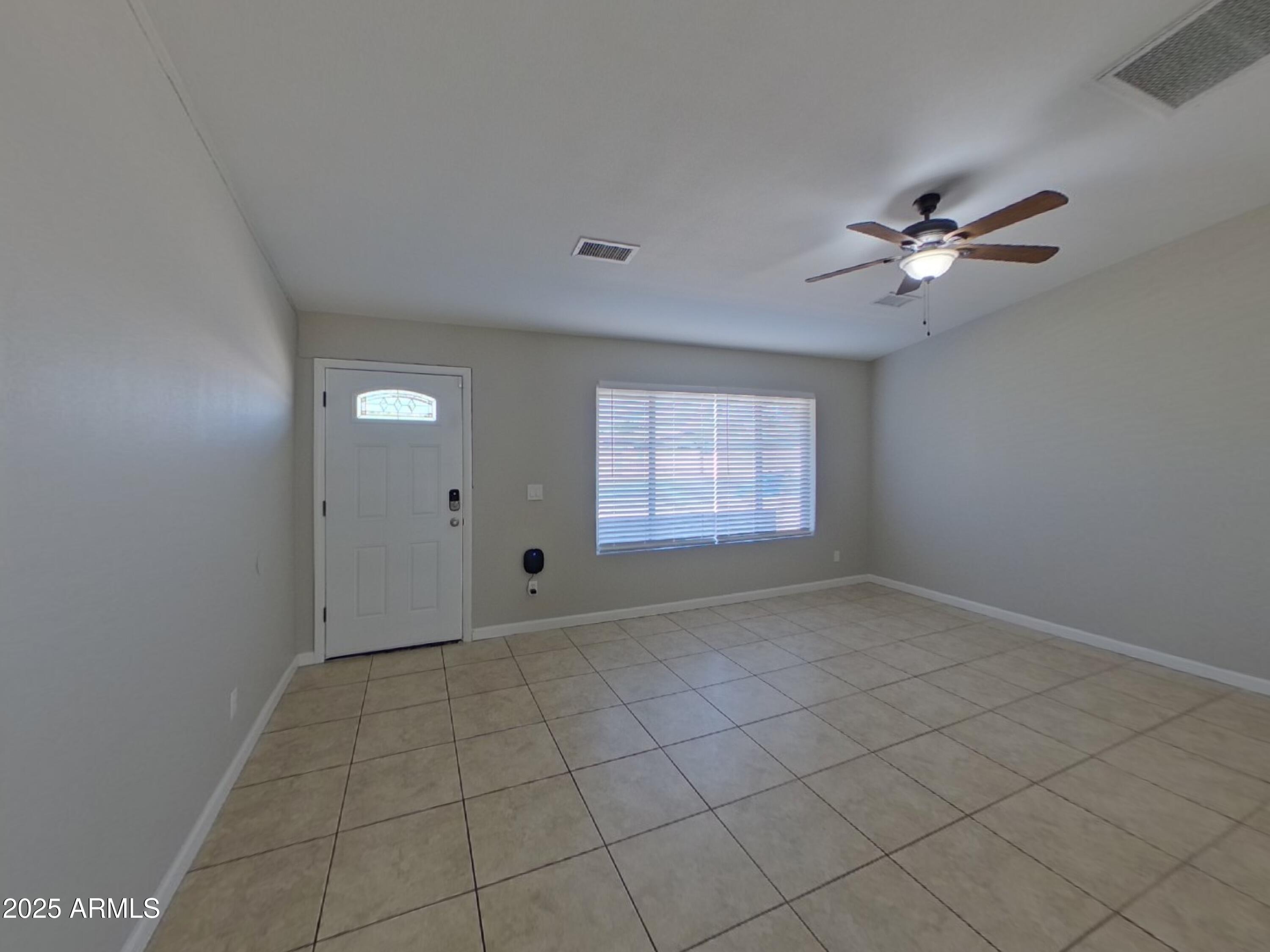 845 South Vineyard Mesa, AZ 85210 - Photo 2 of 26 an empty room with windows and fan