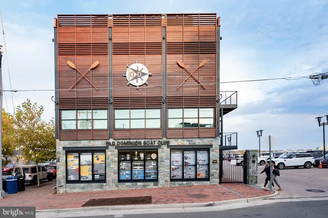 a view of a building with a lot of cars parked on the road