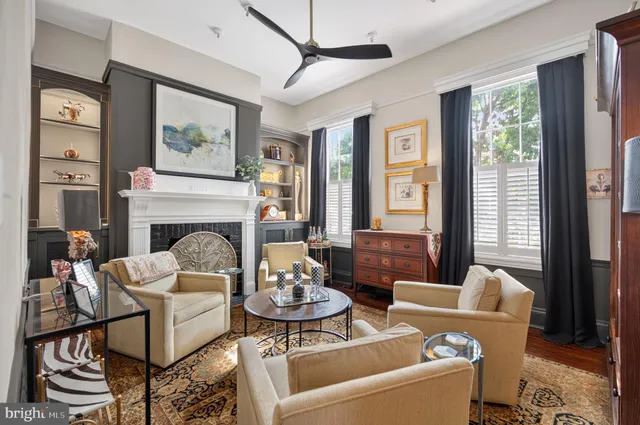 a view of a hallway with wooden floor and a livingroom