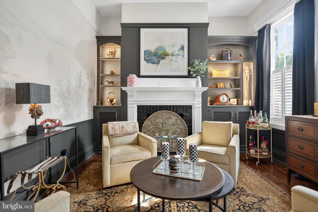 a view of empty room with wooden floor and fireplace