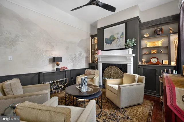 a view of empty room with wooden floor and fireplace