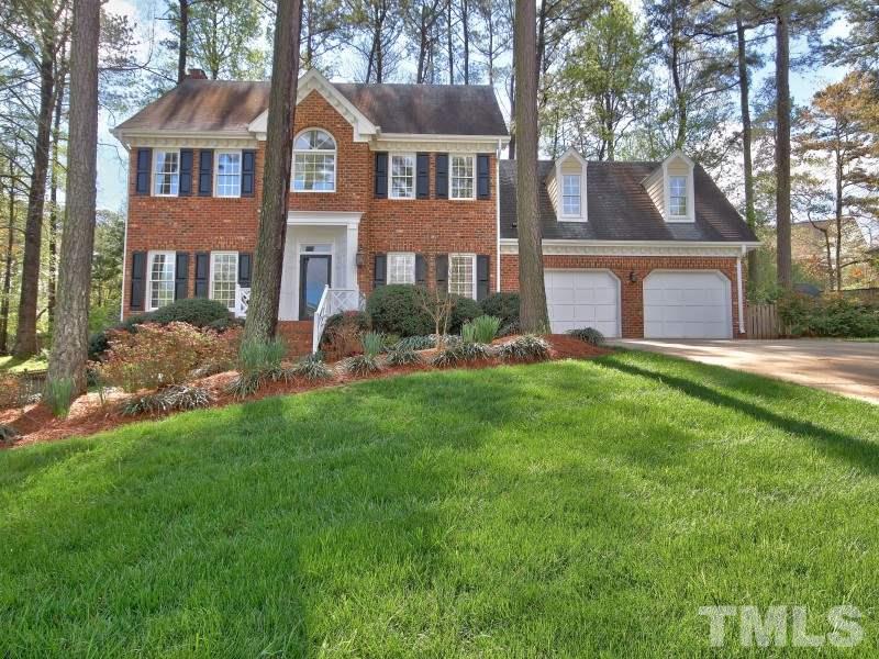 8004 Laurel Mountain Road Raleigh, NC 27613 - Photo 1 of 25 a front view of a house with a yard and trees