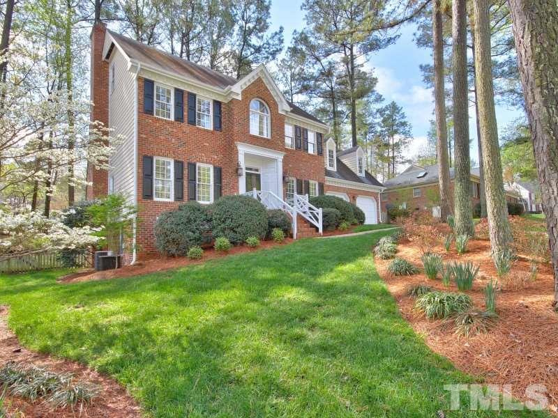 8004 Laurel Mountain Road Raleigh, NC 27613 - Photo 2 of 25 a view of a brick house with a yard and plants
