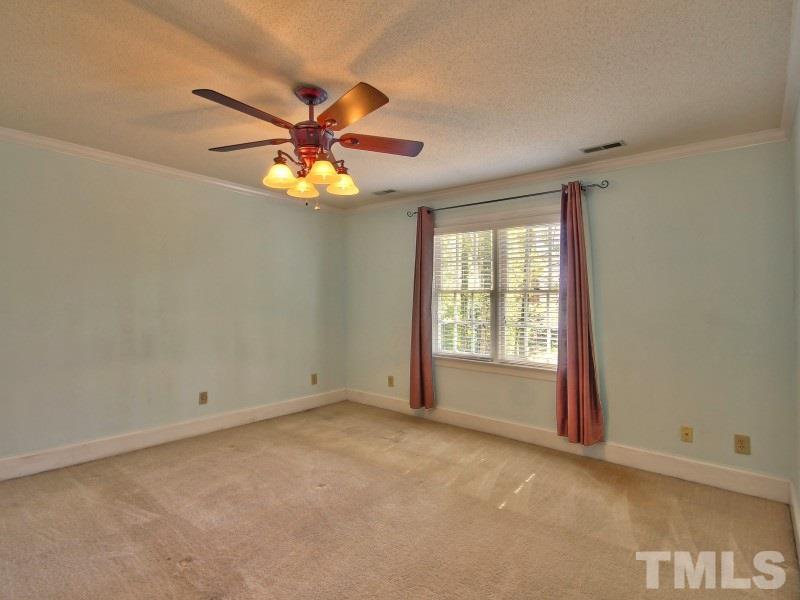 8004 Laurel Mountain Road Raleigh, NC 27613 - Photo 12 of 25 a view of an empty room with window and chandelier fan