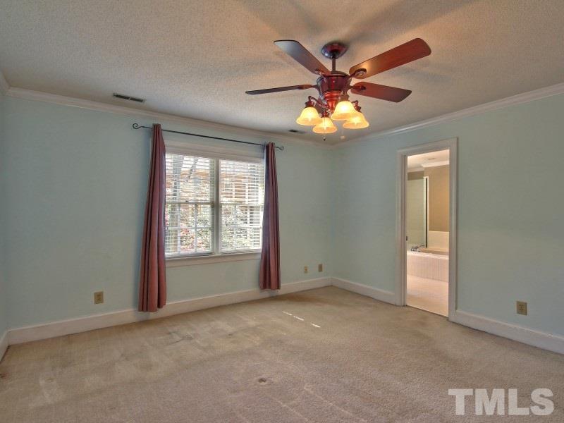 8004 Laurel Mountain Road Raleigh, NC 27613 - Photo 14 of 25 a view of an empty room with window and chandelier fan