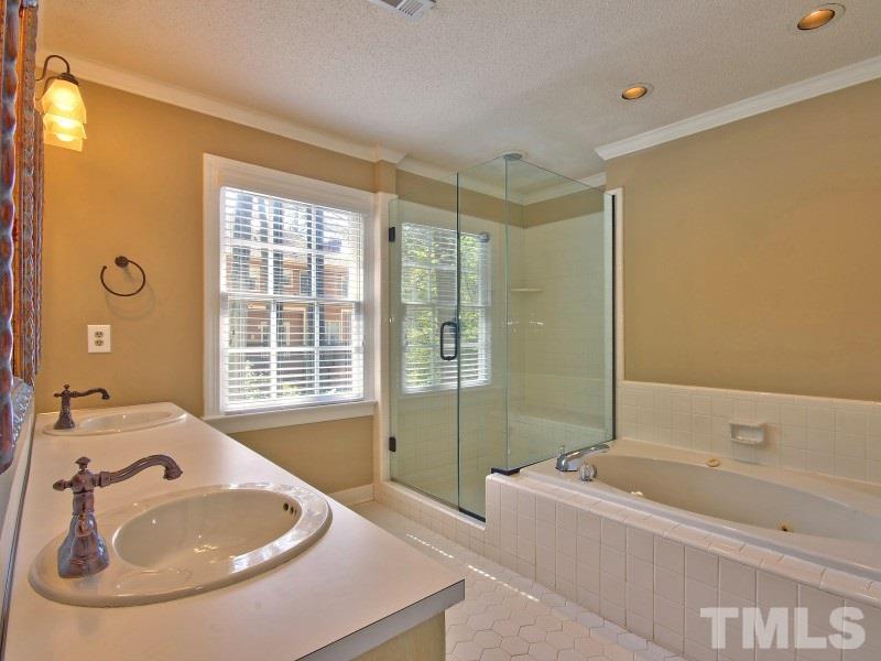 8004 Laurel Mountain Road Raleigh, NC 27613 - Photo 15 of 25 a bathroom with a tub sink and mirror