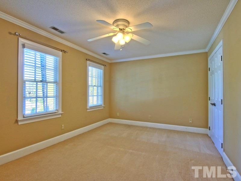 8004 Laurel Mountain Road Raleigh, NC 27613 - Photo 16 of 25 a view of an empty room with chandelier fan and a window