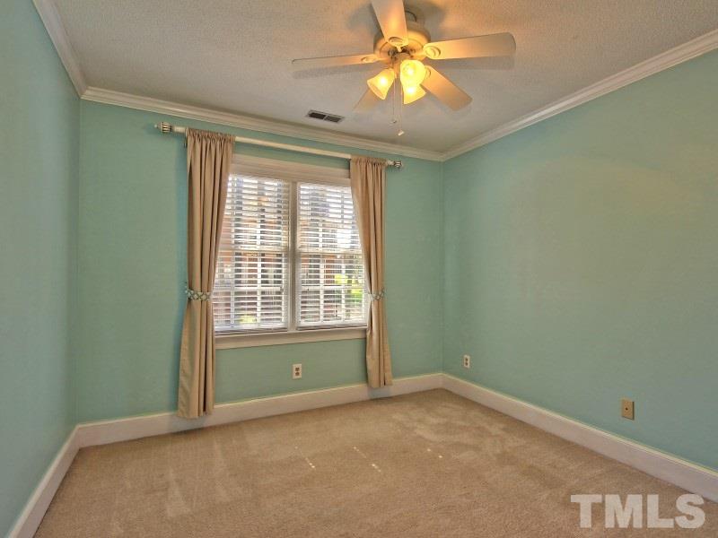 8004 Laurel Mountain Road Raleigh, NC 27613 - Photo 17 of 25 an empty room with a window and a fan