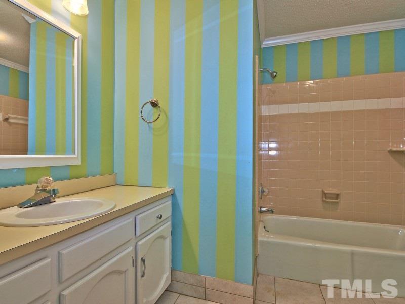 8004 Laurel Mountain Road Raleigh, NC 27613 - Photo 19 of 25 a bathroom with a sink and a mirror