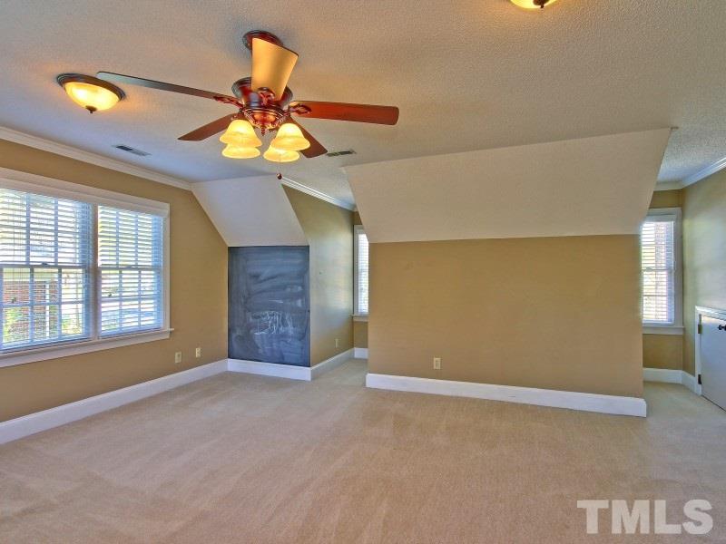 8004 Laurel Mountain Road Raleigh, NC 27613 - Photo 20 of 25 a view of an empty room with window and chandelier fan