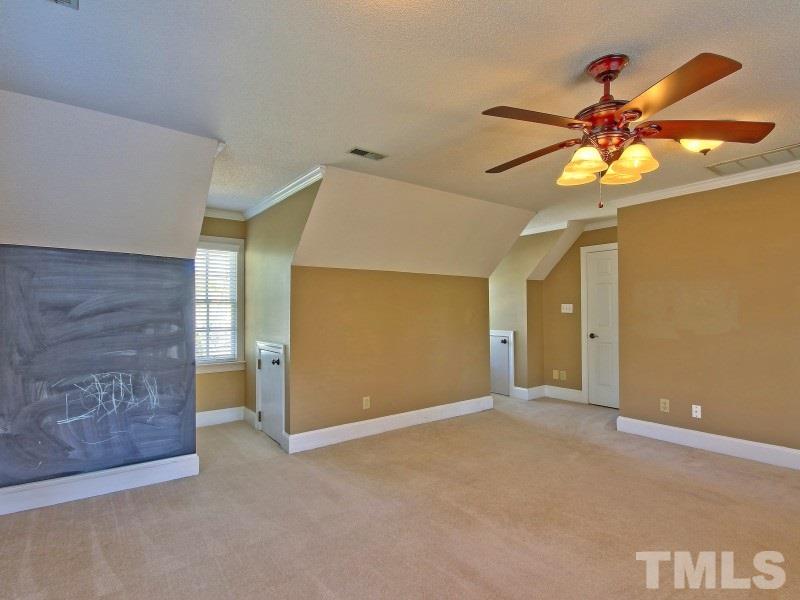 8004 Laurel Mountain Road Raleigh, NC 27613 - Photo 21 of 25 a view of a chandelier fan in a room