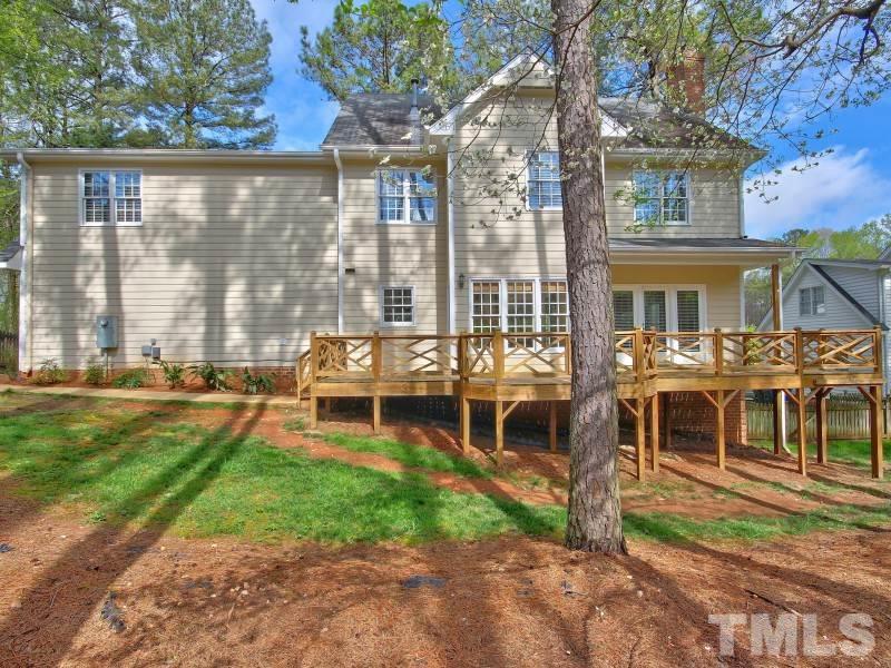 8004 Laurel Mountain Road Raleigh, NC 27613 - Photo 22 of 25 a front view of a house with a yard table and chairs