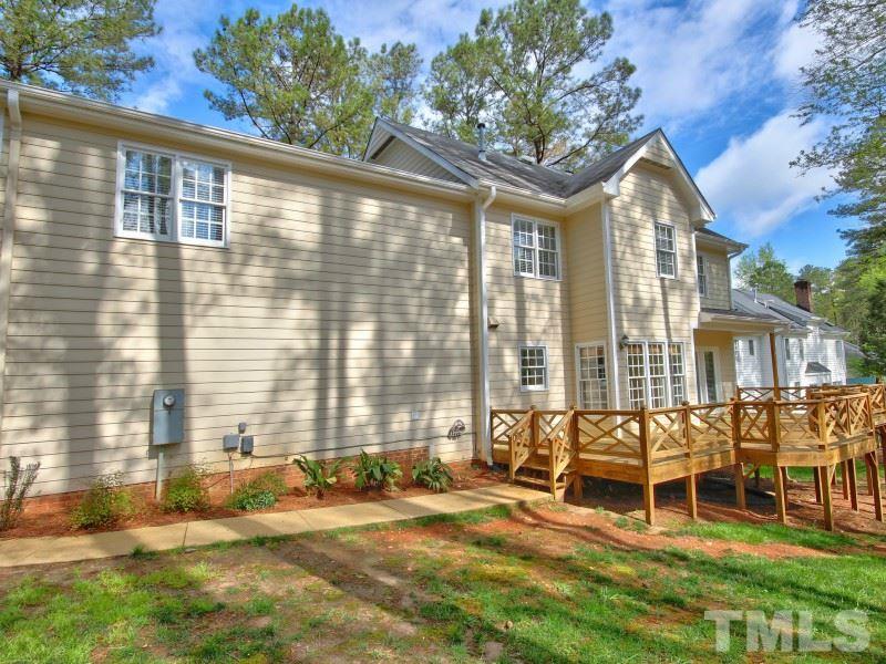 8004 Laurel Mountain Road Raleigh, NC 27613 - Photo 23 of 25 a backyard of a house with a garden and outdoor seating