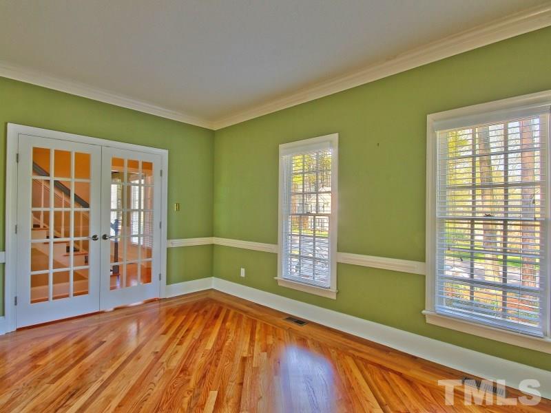 8004 Laurel Mountain Road Raleigh, NC 27613 - Photo 4 of 25 a view of an empty room with wooden floor and a window