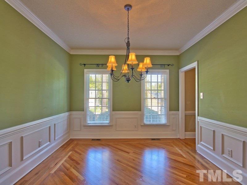 8004 Laurel Mountain Road Raleigh, NC 27613 - Photo 5 of 25 a view of an empty room with window and wooden floor