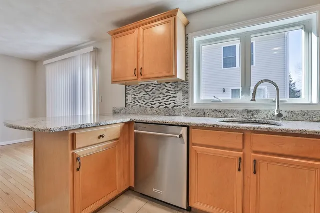 a kitchen with granite countertop cabinets stainless steel appliances and a sink