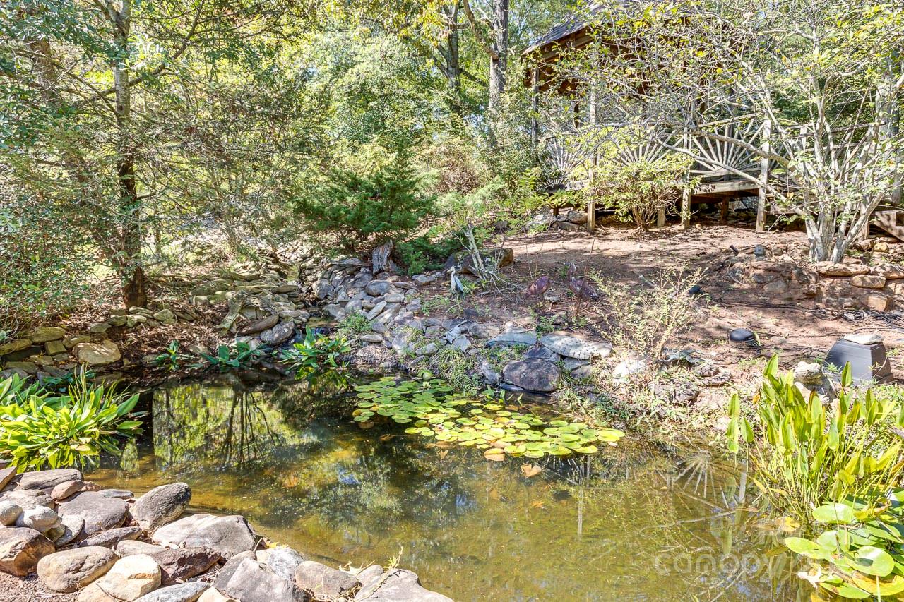 285 Old Batson Road Taylors, SC 29687 - Photo 22 of 48 a backyard of a house with large trees and plants