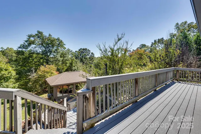a balcony with wooden floor and outdoor space