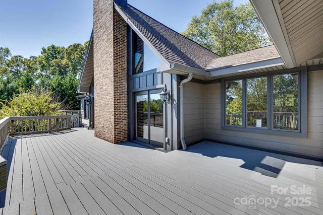 a view of backyard with large trees and plants