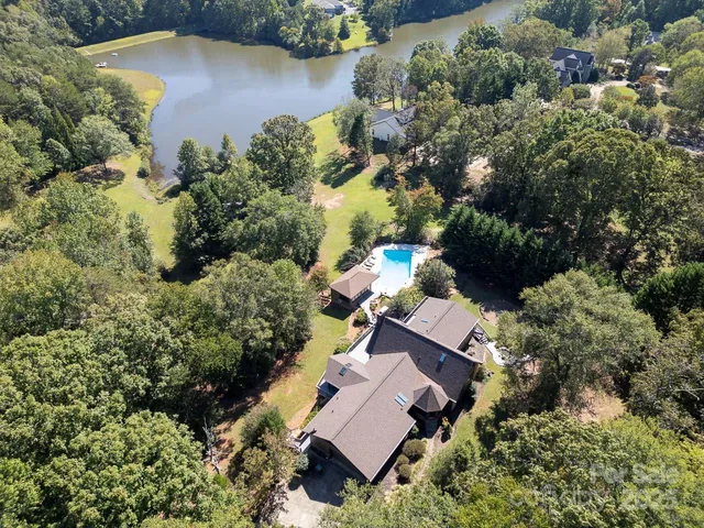 an aerial view of house with yard swimming pool and outdoor seating