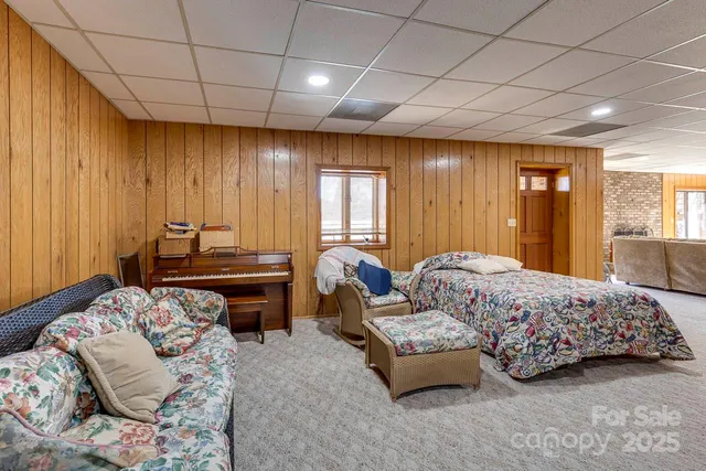 a bedroom with bed couch and window