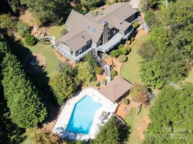 an aerial view of a house with a yard and garden