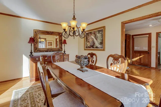 a dining room with furniture and chandelier