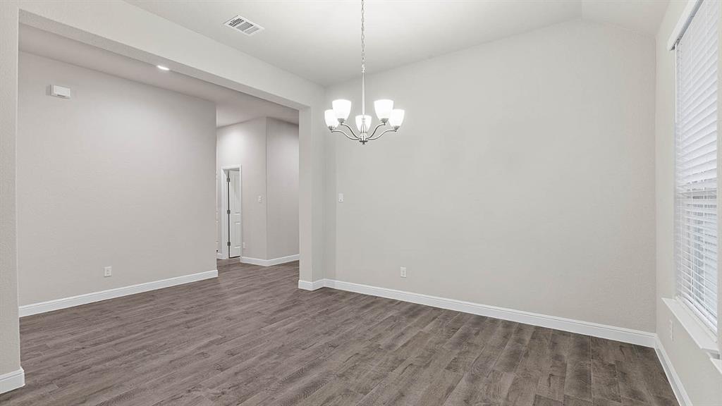 3275 Grayton Street Grand Prairie, TX 76065 - Photo 13 of 36 a view of a room with wooden floor and chandelier
